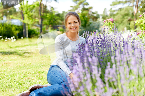 Image of young woman and lavender flowers at summer garden