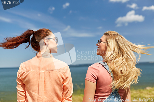 Image of teenage girls or best friends at seaside in summer