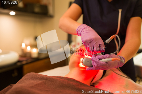 Image of young woman having face microdermabrasion at spa