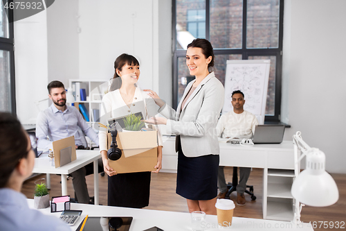 Image of new female employee meeting colleagues at office