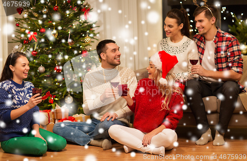 Image of friends celebrating christmas and drinking wine