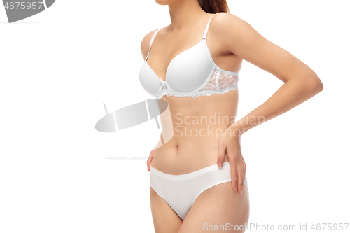 Image of Beautiful female belly isolated on white background. Beauty, cosmetics, spa, depilation, treatment and fitness concept, sensual posing