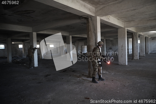 Image of military troops in action urban environment