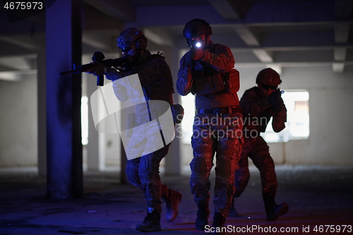 Image of Soldiers squad in tactical formation having action urban environment