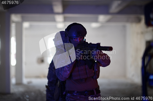 Image of Soldiers squad in tactical formation having action urban environment