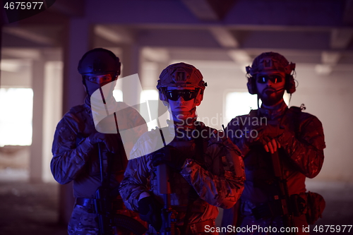 Image of soldier squad team portrait in urban environment colored lightis