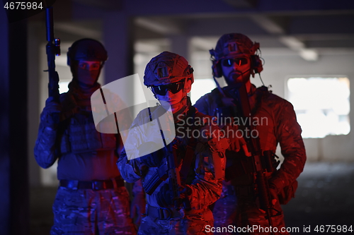 Image of soldier squad team portrait in urban environment colored lightis