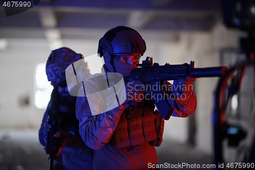 Image of Soldiers squad in tactical formation having action urban environment