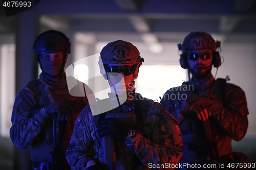 Image of soldier squad team portrait in urban environment colored lightis