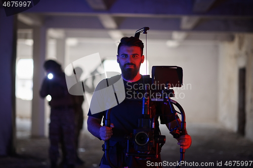 Image of Videographer Taking Action Shoot of Soldiers in Action urban environment