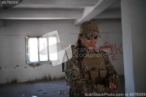 Image of military female soldier having a break