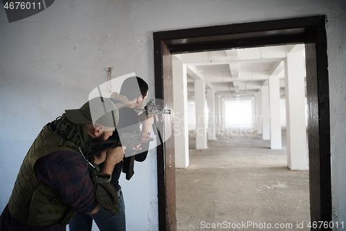 Image of military troops in action urban environment