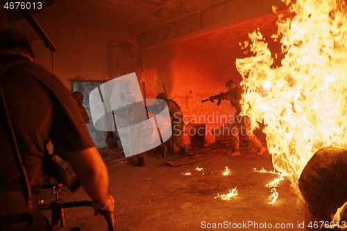 Image of Videographer Taking Action Shoot of Soldiers in Action urban environment