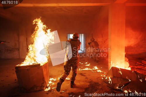 Image of military troops in action urban environment