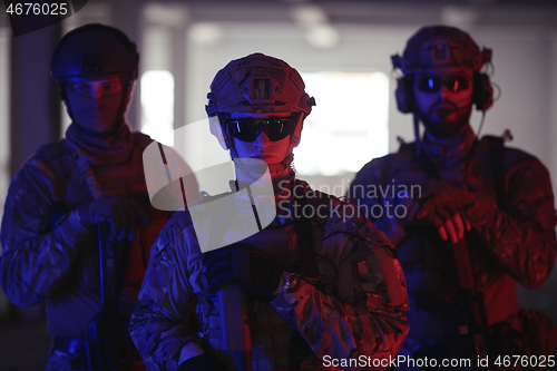 Image of soldier squad team portrait in urban environment colored lightis