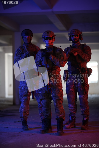 Image of soldier squad team portrait in urban environment colored lightis