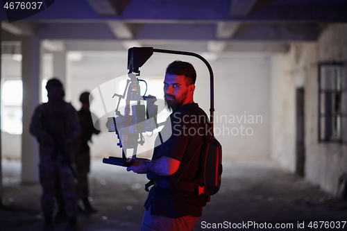 Image of Videographer Taking Action Shoot of Soldiers in Action urban environment