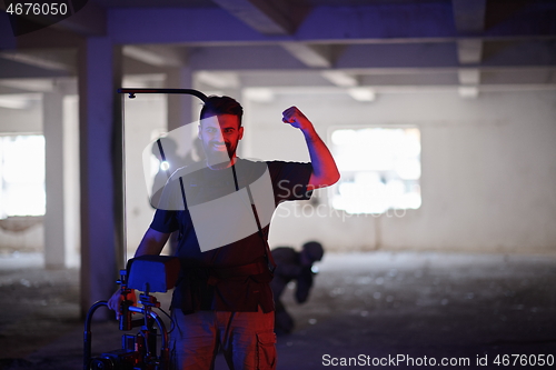 Image of Videographer Taking Action Shoot of Soldiers in Action urban environment
