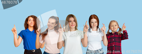 Image of Portrait of young people on light blue studio background, collage