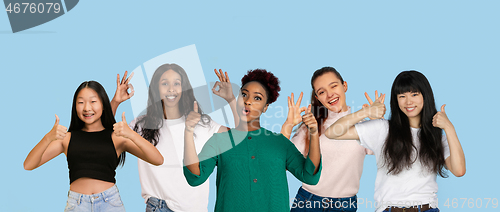 Image of Portrait of young people on light blue studio background, collage