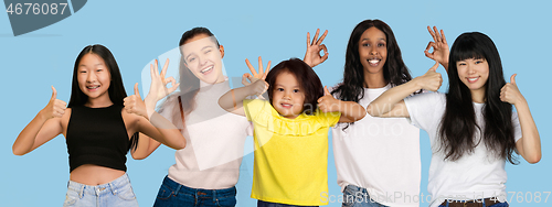 Image of Portrait of young people on light blue studio background, collage