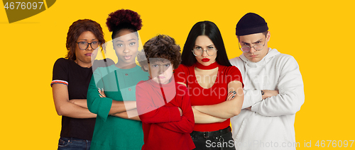 Image of Portrait of young people on bright yellow studio background, collage