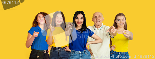 Image of Portrait of young people on bright yellow studio background, collage