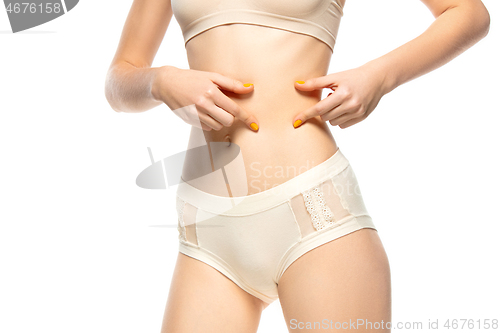 Image of Beautiful female belly isolated on white background. Beauty, cosmetics, spa, depilation, diet, treatment and fitness concept