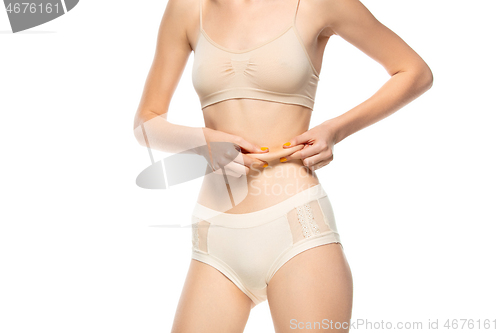 Image of Beautiful female belly isolated on white background. Beauty, cosmetics, spa, depilation, diet, treatment and fitness concept