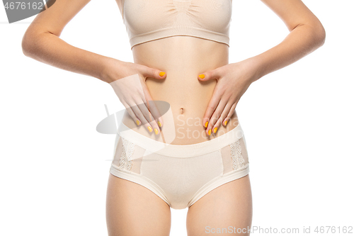 Image of Beautiful female belly isolated on white background. Beauty, cosmetics, spa, depilation, diet, treatment and fitness concept