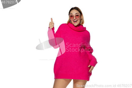 Image of Beautiful young woman in bright pink comfortable sweater, long sleeve isolated on white studio background