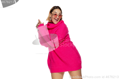 Image of Beautiful young woman in bright pink comfortable sweater, long sleeve isolated on white studio background