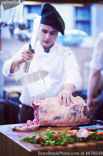 Image of chef cutting big piece of beef