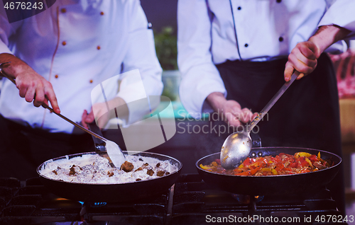 Image of team cooks and chefs preparing meals