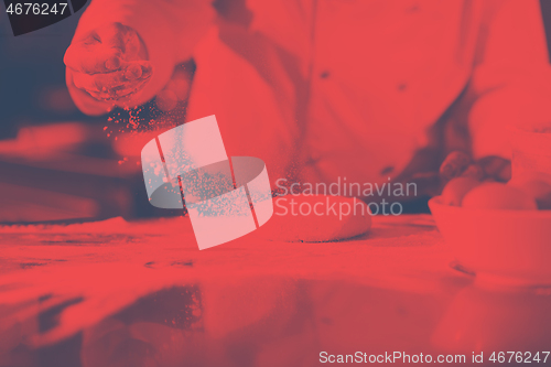 Image of chef hands preparing dough for pizza