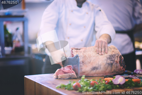 Image of chef cutting big piece of beef