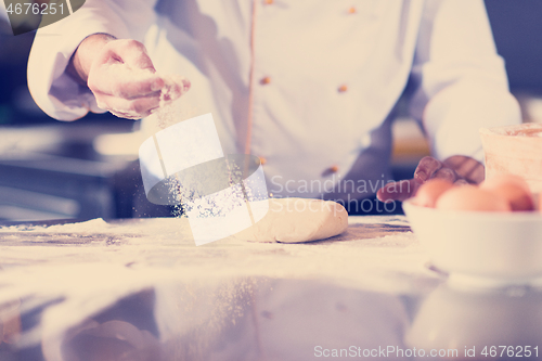 Image of chef hands preparing dough for pizza