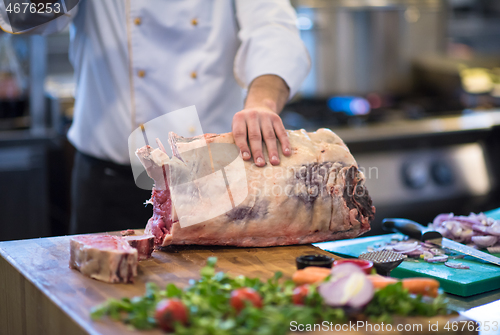 Image of chef cutting big piece of beef