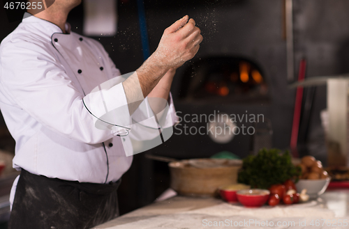 Image of chef throwing up pizza dough