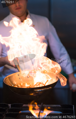 Image of Chef doing flambe on food