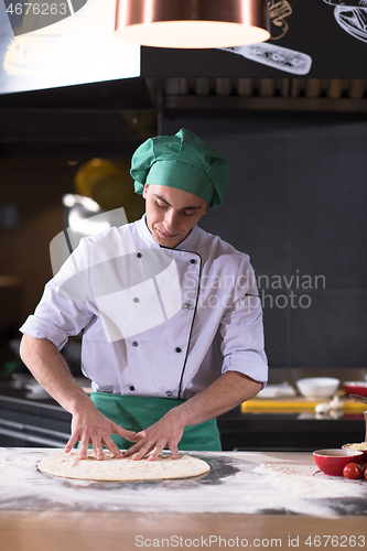 Image of chef preparing dough for pizza