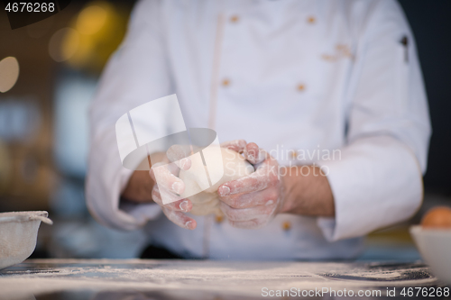 Image of chef hands preparing dough for pizza