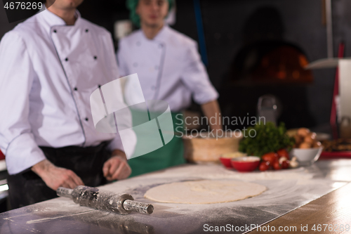 Image of chef preparing dough for pizza