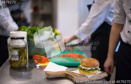 Image of chef finishing burger