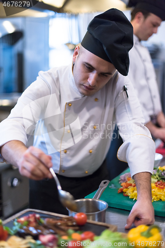 Image of Chef finishing steak meat plate