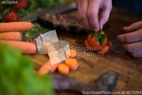 Image of closeup of Chef hands preparing beef steak