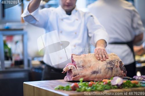 Image of chef cutting big piece of beef