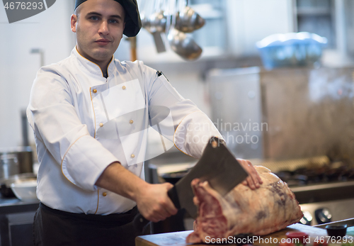 Image of chef cutting big piece of beef