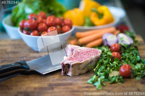 Image of Juicy slice of raw steak on wooden table