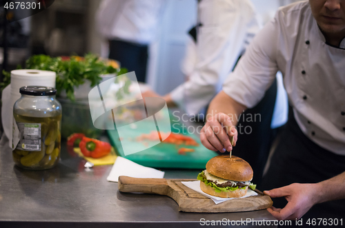 Image of chef finishing burger